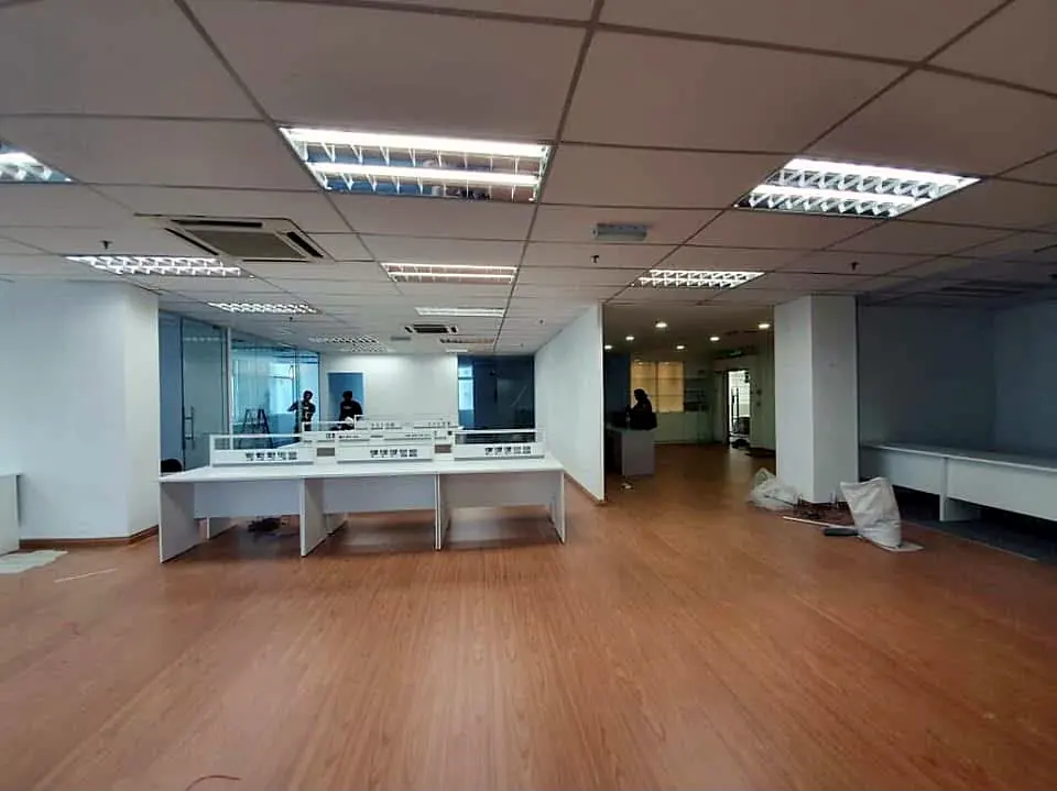 After: the same area finished, beside a glass-walled room