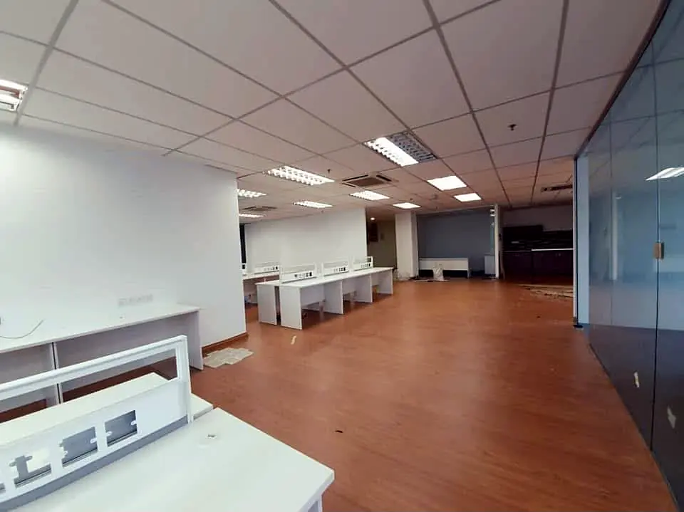 After: new workstations along a glass-walled corridor