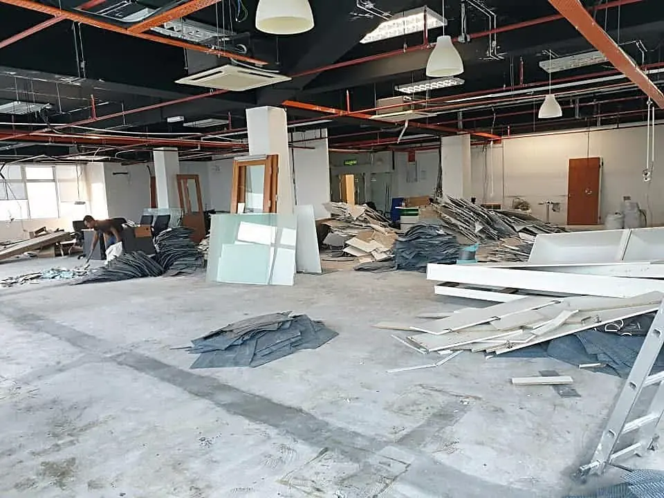 Before: the floor cleared to bare concrete, ceiling services exposed