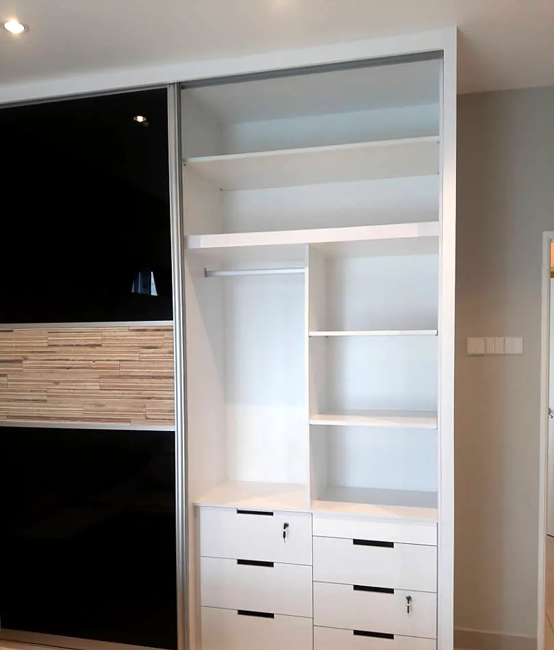Built-in wardrobe with black glass sliding doors